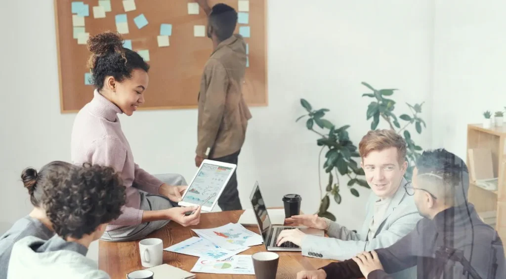 Professionals working together on a business project, representing the career opportunities that come with an online business degree