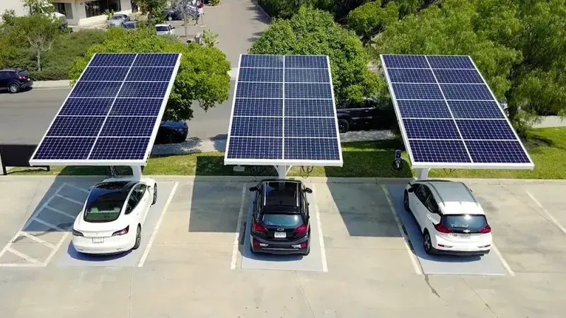 Electric vehicle charging at a solar-powered station 2025
